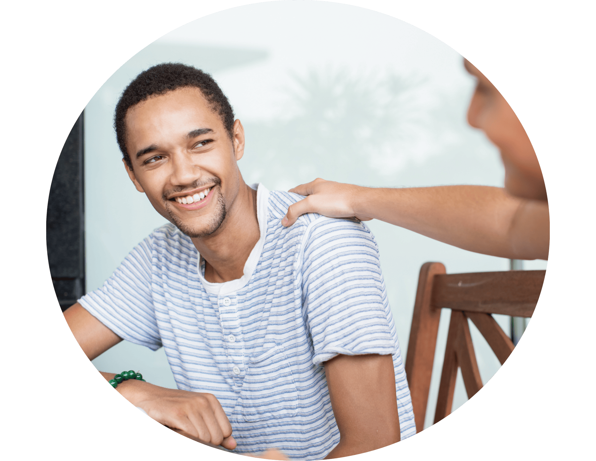 Hand on shoulder of student, showing support